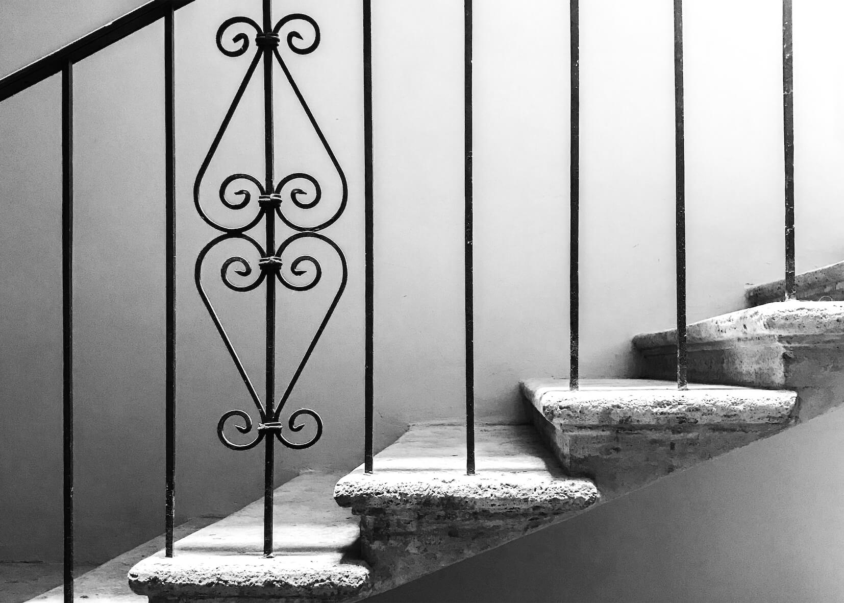 Heritage staircase — wrought iron and stone detail