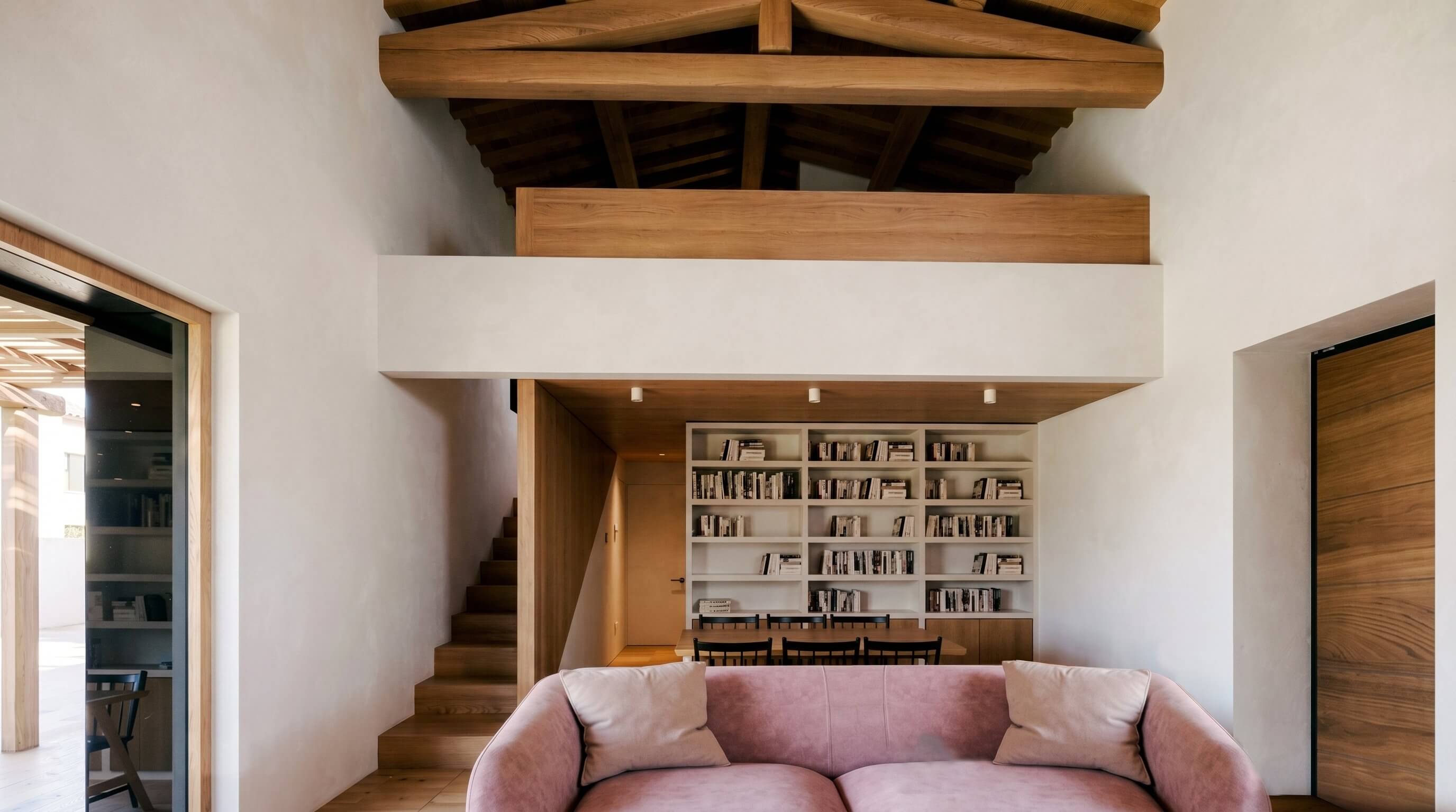 Interior — exposed timber roof structure and bookshelves