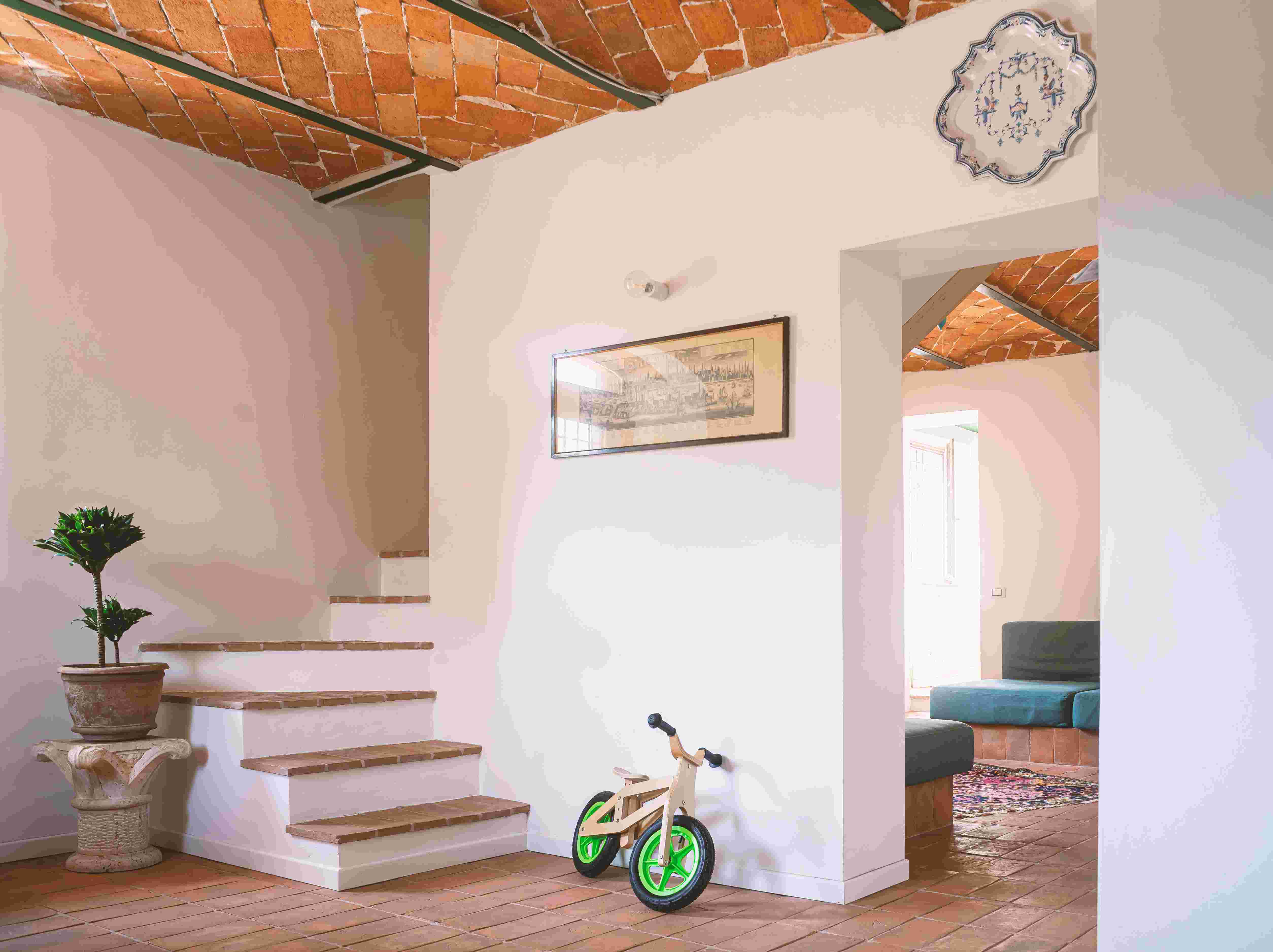 Restored farmhouse interior — entrance with terracotta floor and brick ceiling
